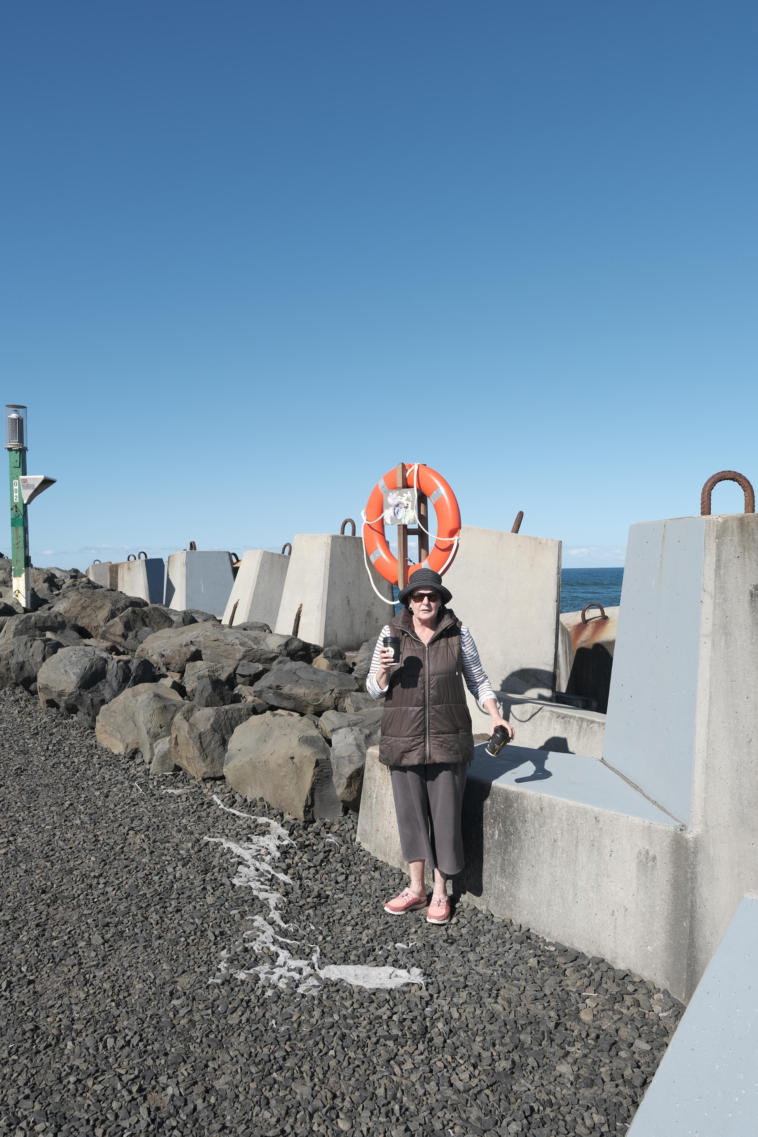 image of woman standing in front of lifebuoy
